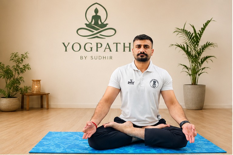 Sudhir seated in meditation beneath the Yog Path wall mark